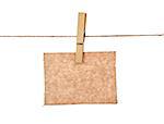 sheet of kraft paper hanging on a rope with clothespin on a white background