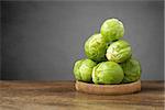 A heap of fresh brussels sprouts on wooden table
