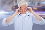 Man with headache against blurred new york street