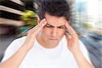 Man with headache against new york street