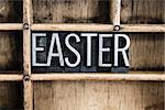 The word "EASTER" written in vintage metal letterpress type in a wooden drawer with dividers.