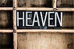 The word "HEAVEN" written in vintage metal letterpress type in a wooden drawer with dividers.