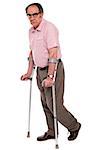 Depressed senior male standing with two crutches isolated over white