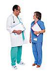 Male and female doctors discussing a case with clipboards in hand
