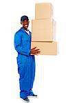 Smiling young delivery boy holding cardboard boxes isolated on white background
