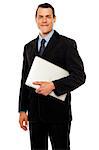 Handsome business executive holding laptop isolated against white background