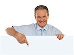 Casual male promoter pointing at blank billboard isolated over white