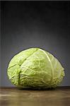 A single cabbage on a wooden table