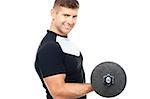 Side pose of gym instructor lifting weights. Toning his biceps