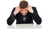 Frustrated young businessman. Hands on his head