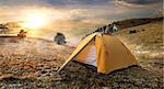 Tourist tent in autumn mountains at sunrise