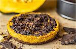 Pumpkin Pie with Dark Chocolate on Wooden Table