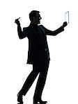 one  business man holding digital pen stylus tablet in silhouette on white background