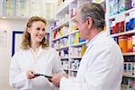 Team of pharmacist holding clipboard at hospital pharmacy