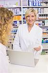 Pharmacist using the computer at pharmacy