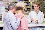 Pharmacist explaining something to a customer in the pharmacy