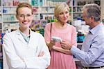 Pharmacist smiling at camera at pharmacy