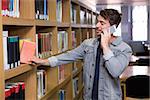 Student talking on the phone in library at the university