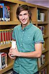 Student smiling at camera in library at the university