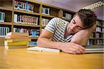Student asleep in the library at the university