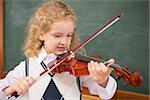 Cute pupil playing the violin at elementary school