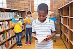 Pupils looking for books in library at elementary school