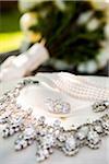 Close-up of Earrings and Necklaces with Bridal Bouquet