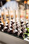 Close-up of Chocolate Tuxedo Lollipops on Dessert Table