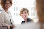 Portrait of women smiling against window