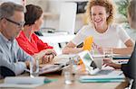 People talking and smiling during business meeting