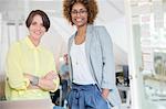 Portrait of female colleagues smiling in office