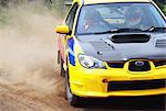 Rally car racing on dirt track