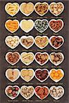 Savory snack party food selection in heart shaped porcelain bowls with titles