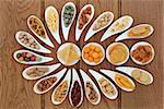 Savoury snack party food selection in porcelain dishes over oak background.