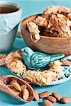 Homemade almond crescent cookies on teal background