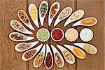 Savoury snack and dip food selection in porcelain dishes over oak background.