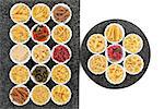 Pasta dried food selection in porcelain crinkle bowls on marble rectangle and round slabs over white background.