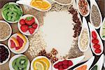 Health food selection in porcelain bowls over natural speckled hemp paper notebook.