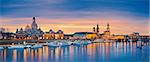 Panoramic image of Dresden, Germany during sunset with Elbe River in the foreground.