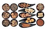 Chinese herbal medicine selection in black bowls  over white background.
