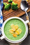 Broccoli cream soup with croutons on table