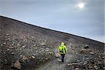 Woman is taking a trail to the top of yhe Hverfjall crater in Northern Iceland