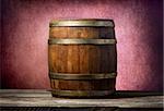 Wooden barrel on a table and pink background