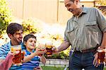 Three generation family toasting in garden