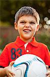 Boy with football, making faces