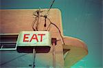 Low angle view of eat sign on cafe wall, Pescardero, California, USA