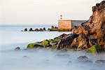 Concrete wave breakers in sea and rocky coast