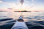 Kayak on water at sunset