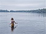 Girl in lake, rear view