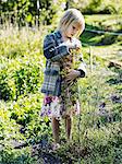 Girl with fennel flowers on vegetable patch